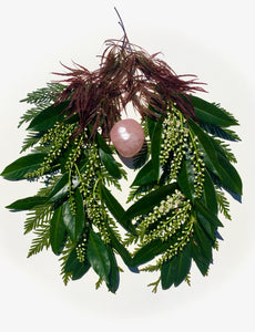 Cherry laurel leaves and blossoms form lungs around a rose quartz heart